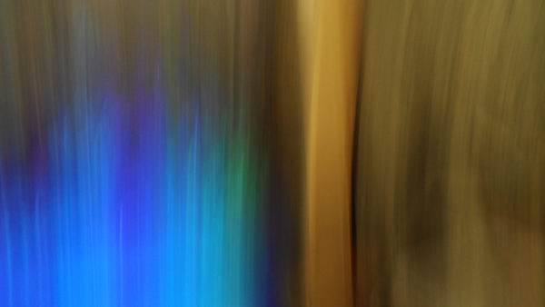 Gold, green, and blue cover the page in paint brush style artistic blur photography