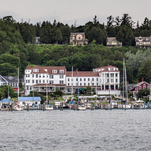 view from lake huron of stately old houses on mackinac island michigan