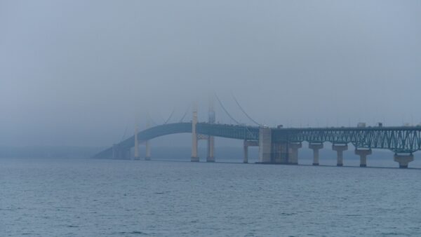 large suspension bridge over lake huron disappears into the fog