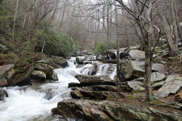 waterfall running off mountain over large rocks