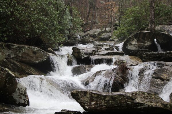 waterfall running off mountain over large rocks