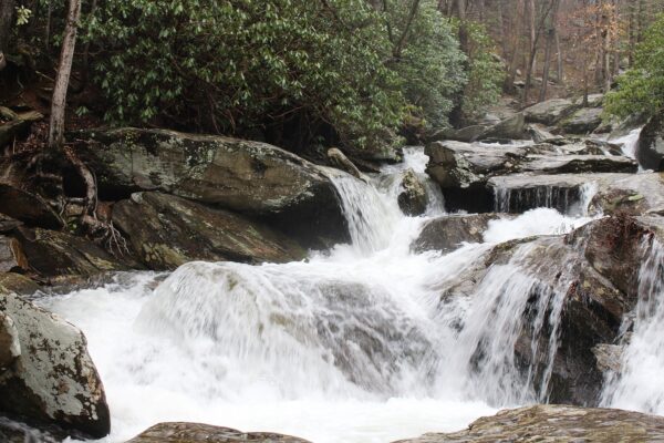 waterfall running off mountain over large rocks